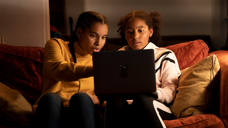 Two girls looking at a laptop