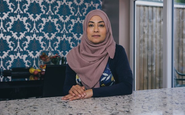 Adult woman sitting at kitchen counter