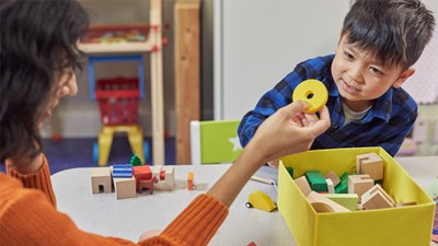 A child playing with toys at a nursery.