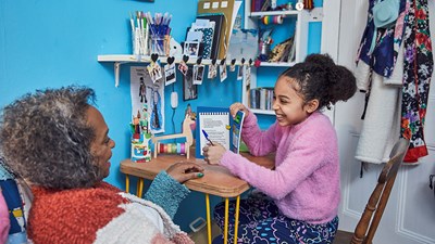 Grey haired black woman and young girl