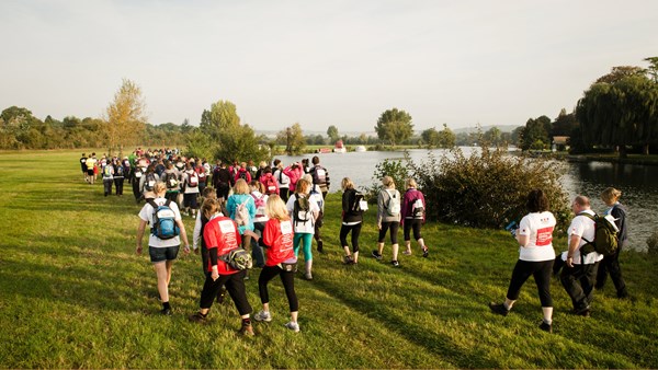 Group of runners on a riverside pathway