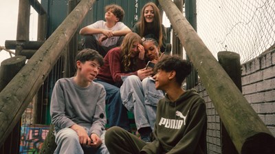Photograph of a group of teenagers in a park.