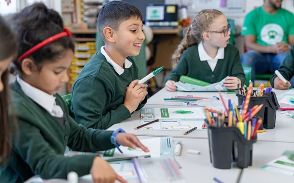 A primary school pupil smiling during a Speak out Stay safe session.