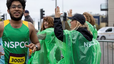 A member of Team NSPCC smiling while taking part in a running event.