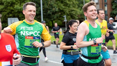 A member of Team NSPCC smiling while taking part in a running event.