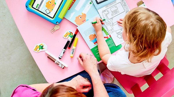 child sat at table completing a Techosaurus activity pack