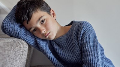 A young child staring blankly into the distance.