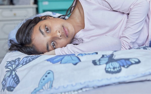 Girl lying on her bed