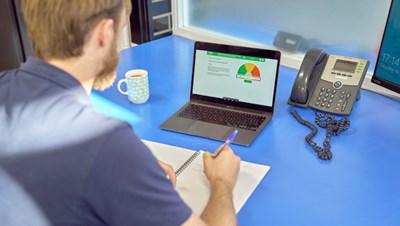 Photograph of a man working on a laptop.
