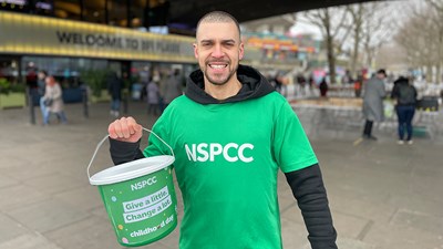 Volunteer holding NSPCC collection bucket