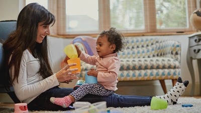 Mum and toddler playing with cups