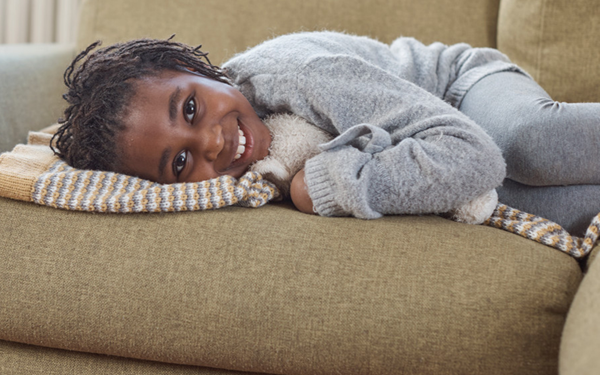 Girl lying on sofa smiling