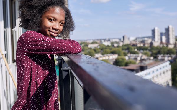 Girl smiling outside home