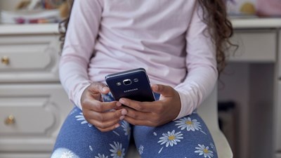 A young girl on her mobile.