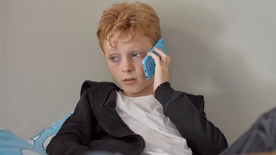 Young boy on phone