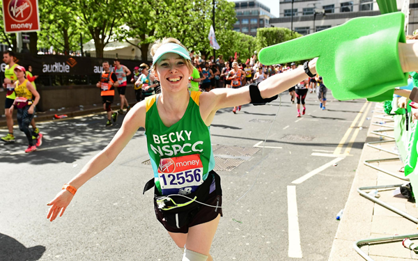 Team NSPCC runner high fiving a supporter