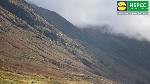 Mountain landscape layered with NSPCC/Lidl Northern Ireland official partnership logo