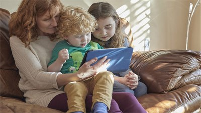 Mother and small children looking at tablet