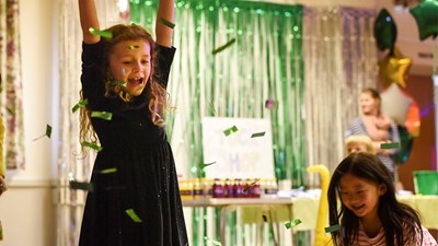 Two young girls playing at a party.