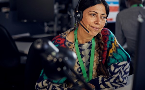 An NSPCC child protection specialist smiling on a Helpline call.