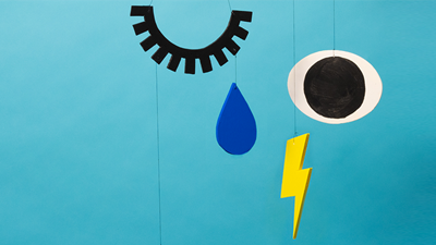 Abstract illustration showing a mobile which has four items representing crying: an eye, an eyelash, a tear and a lightning bolt