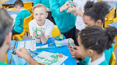Children in classroom creating origami