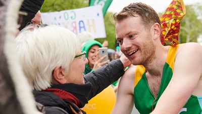 A man greets his mother after running a marathon
