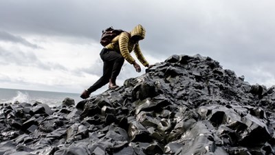 A man scrambling on rocks
