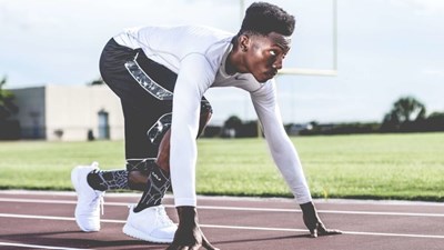 A man prepares to run on a race track
