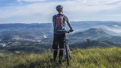 A man on top of a hill with a mountain bike