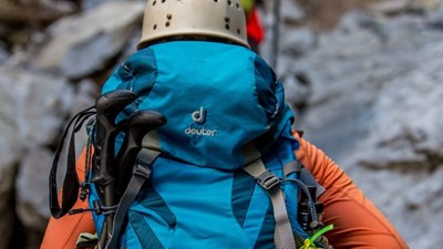 Two people hiking with rucksacks and helmets