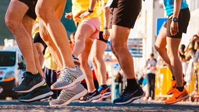 A group of runners feet at the beginning of a race