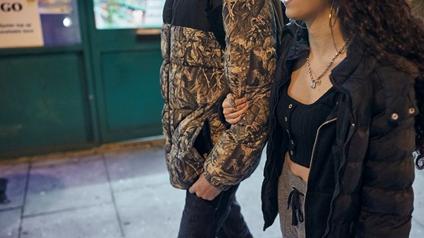 Young couple walking together with arms linked