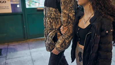 Young couple walking together with arms linked
