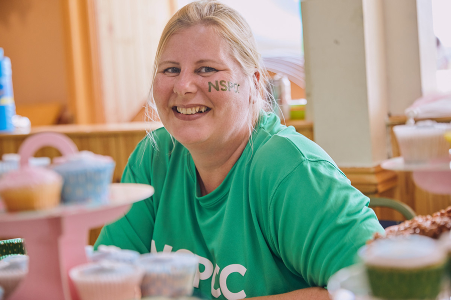 Smiling woman volunteering at fundraising event