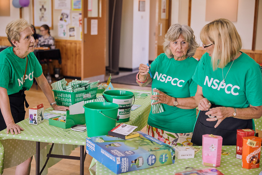 3 women volunteering together at a community fundraising event
