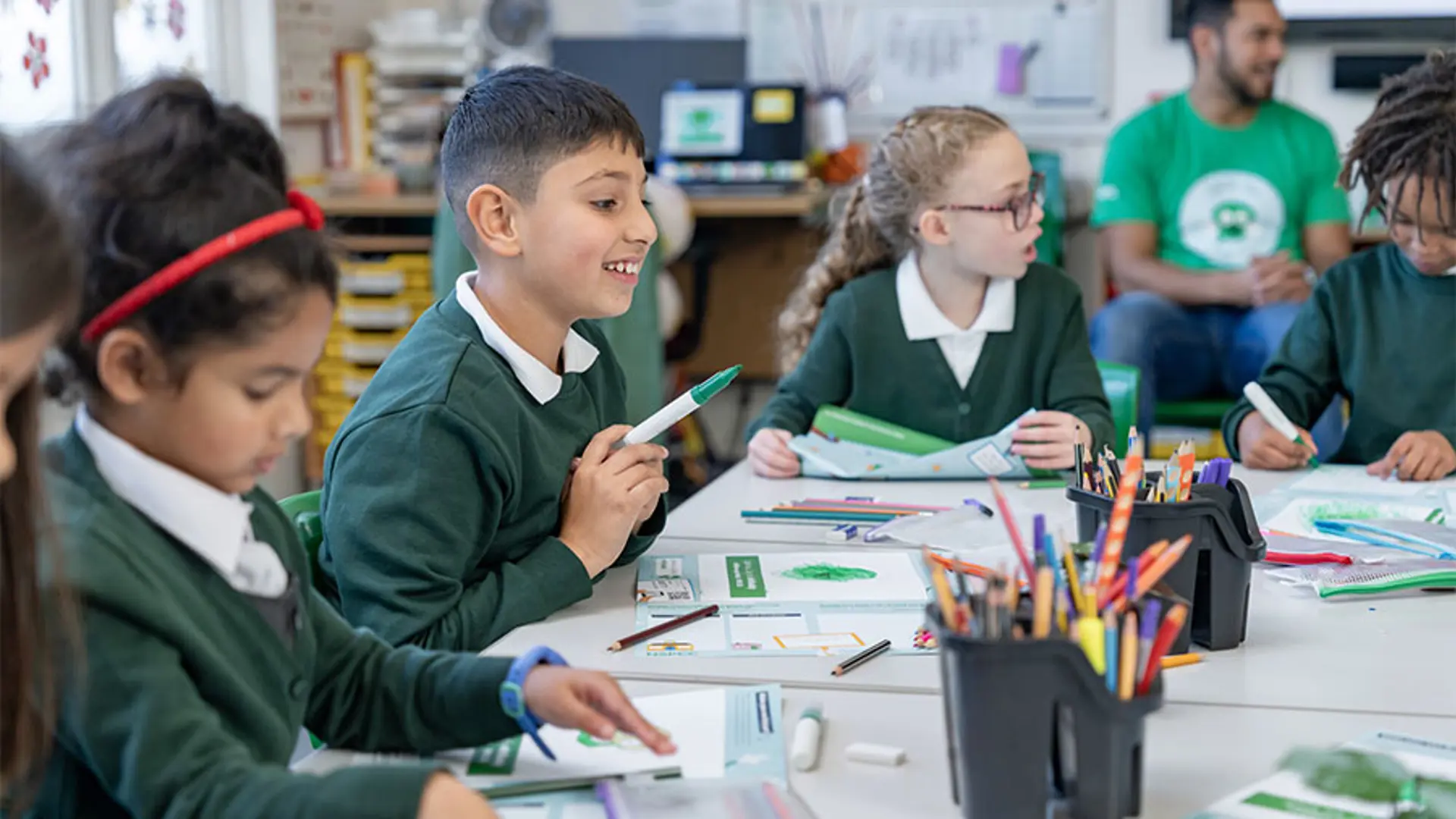A primary school pupil smiling during a Speak out Stay safe lesson.