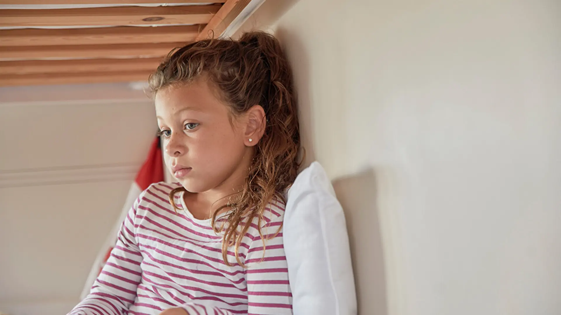 A child staring blankly into the distance.
