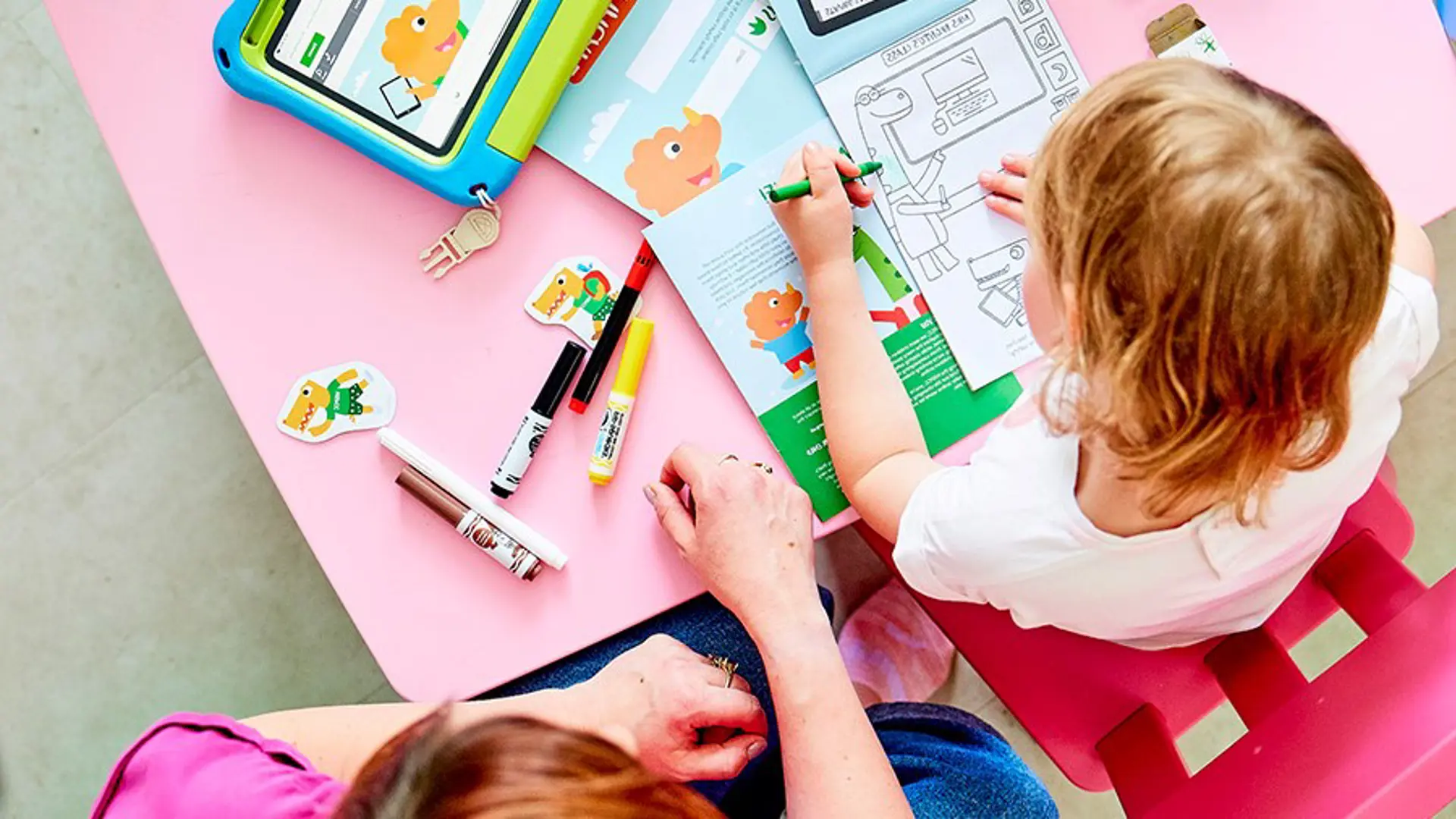 child sat at table completing a Techosaurus activity pack