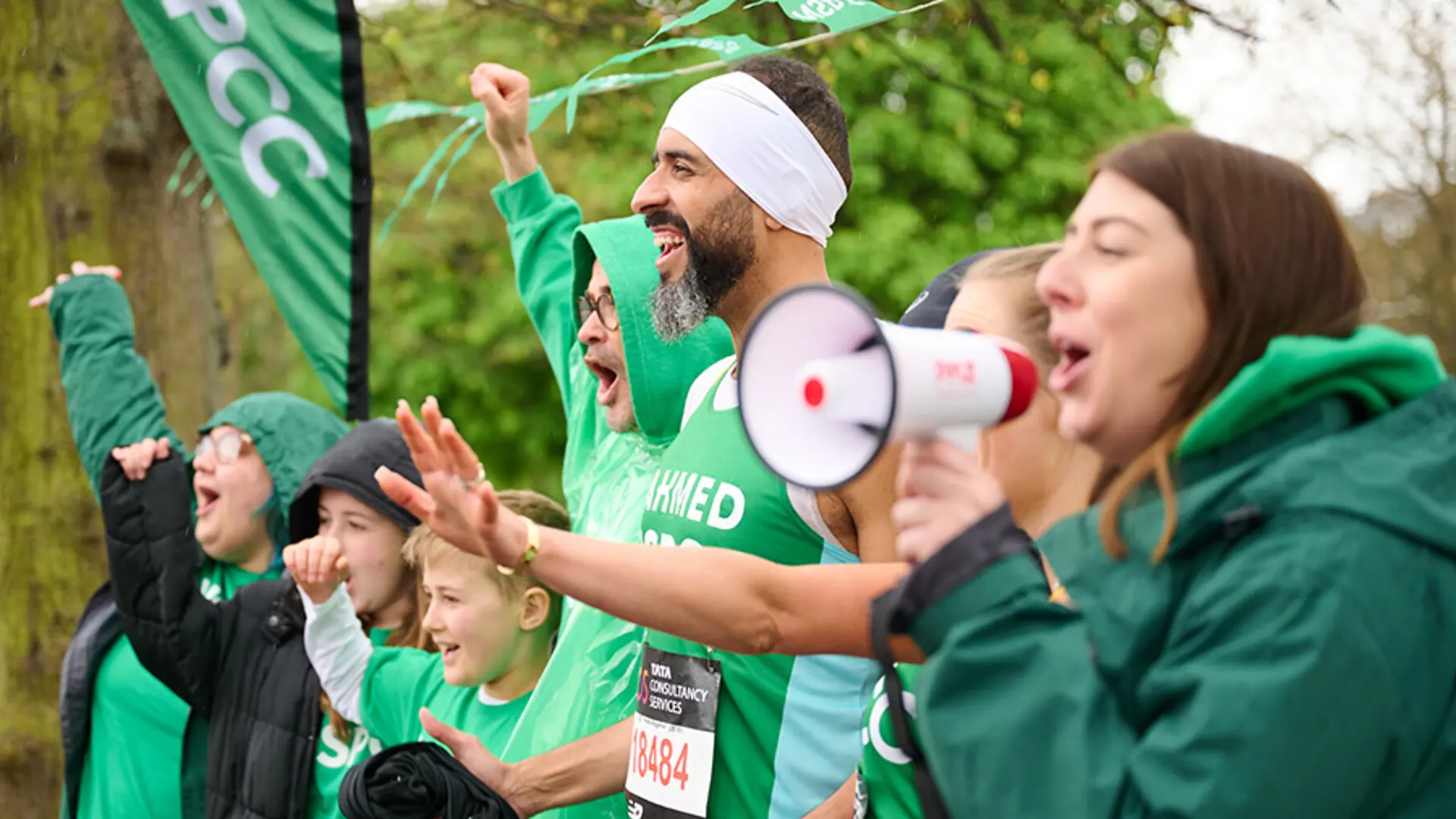 Photograph of NSPCC volunteers cheering at a fundraising race.