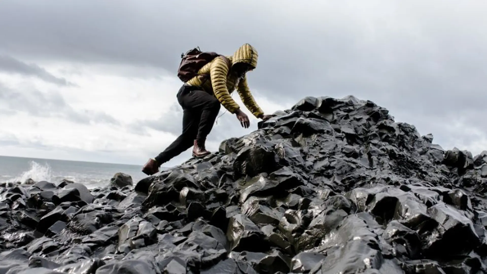 A man scrambling on rocks