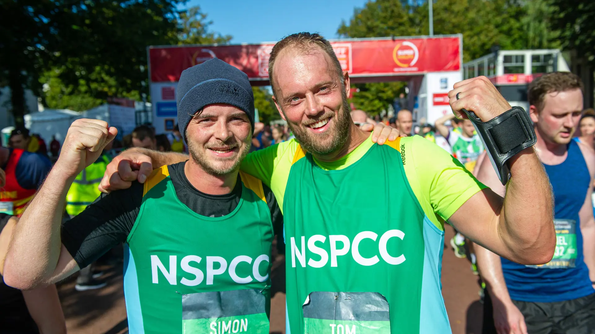 Two #TeamNSPCC runners celebrating at a race