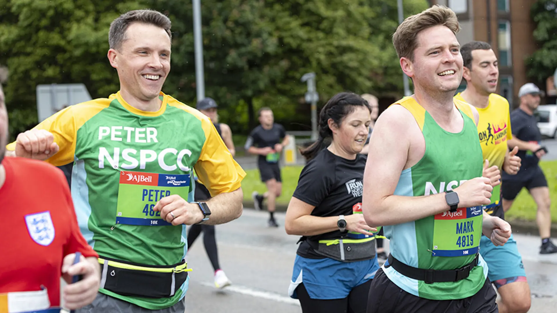 A member of Team NSPCC smiling while taking part in a running event.