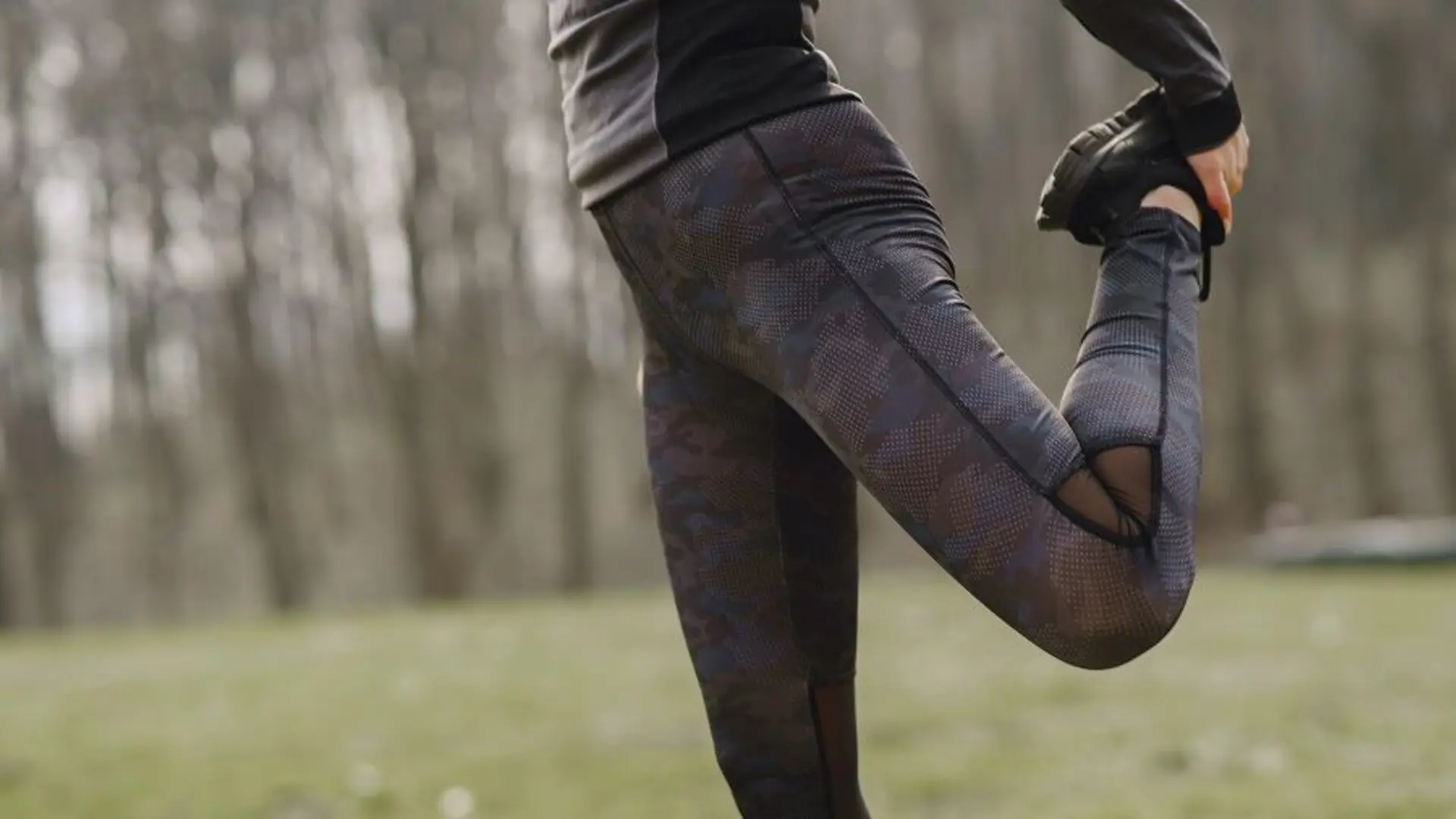 A woman stretching legs in park