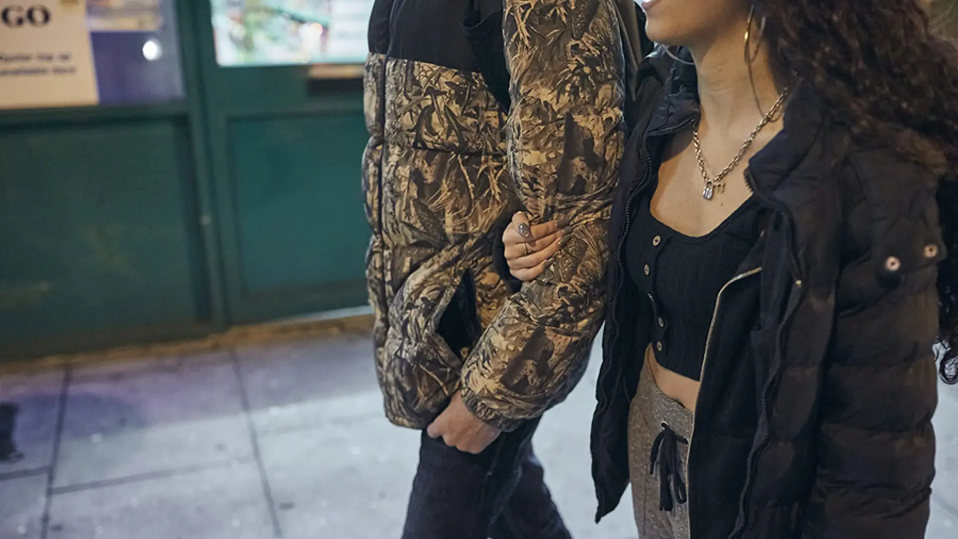 Young couple walking together with arms linked